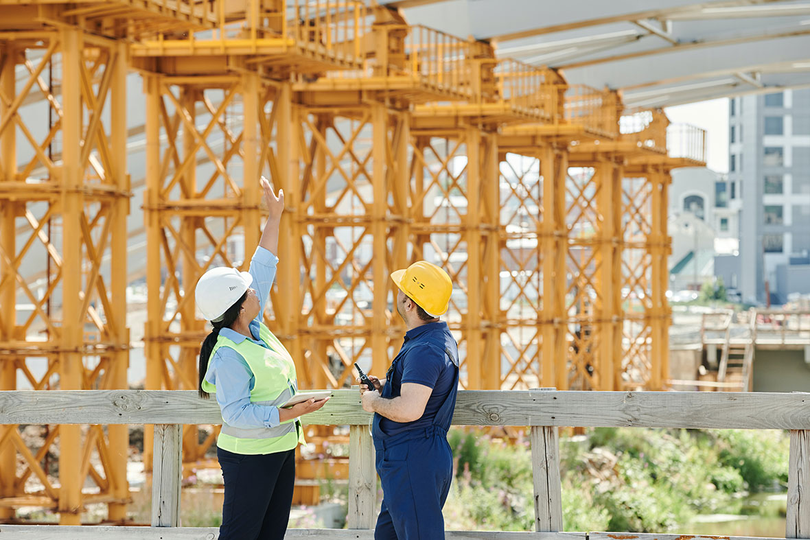 A woman and man talking at a construction site